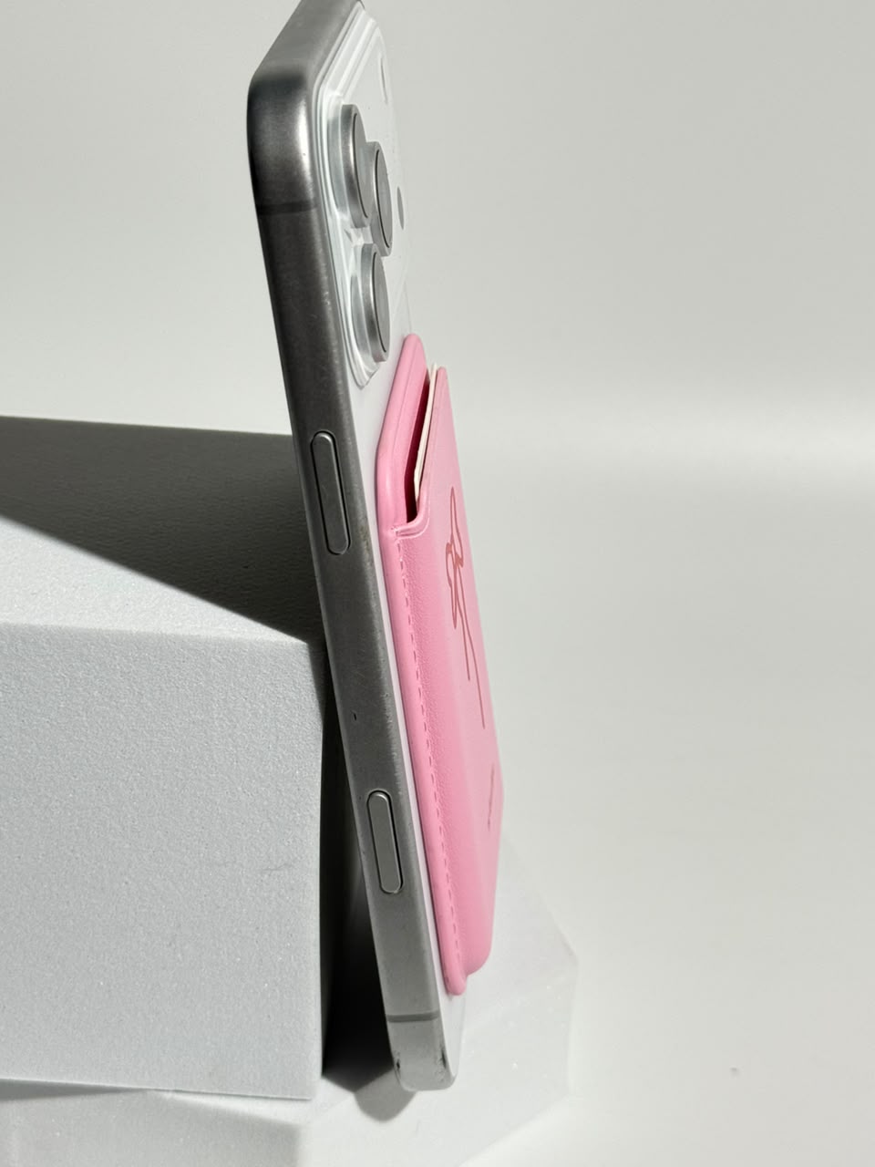 Pink bow MagSafe wallet side view on iPhone