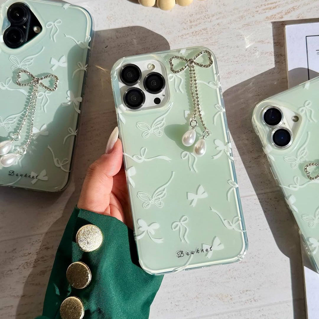 Mint bow phone case showing pearl charm detail and butterfly accent
