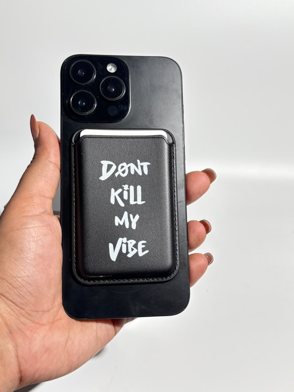 Don't Kill My Vibe black MagSafe wallet on iPhone