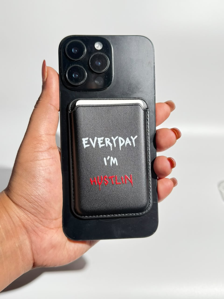 Black Everyday I'm Hustlin MagSafe wallet on iPhone