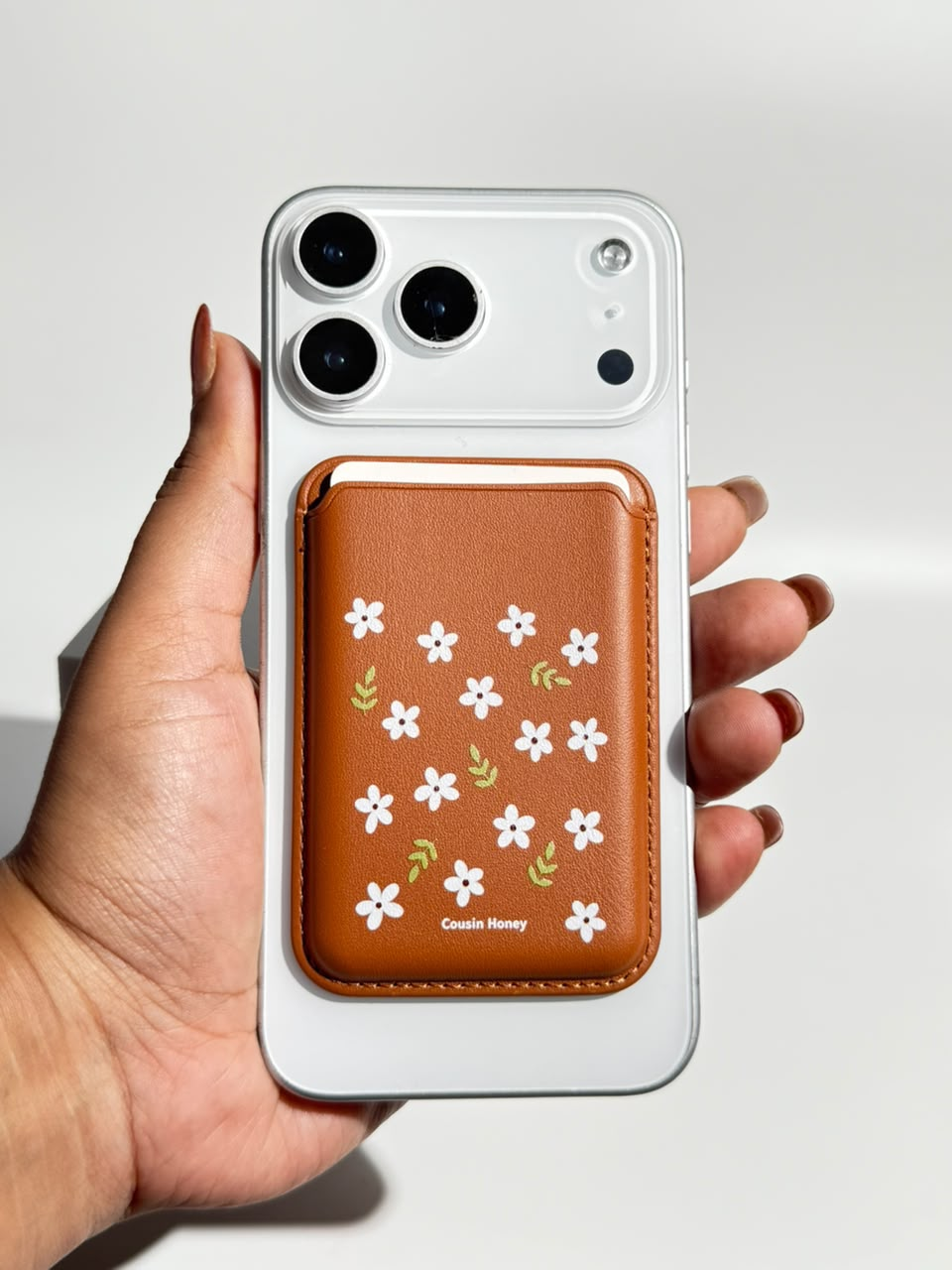 Brown daisy print MagSafe wallet on iPhone