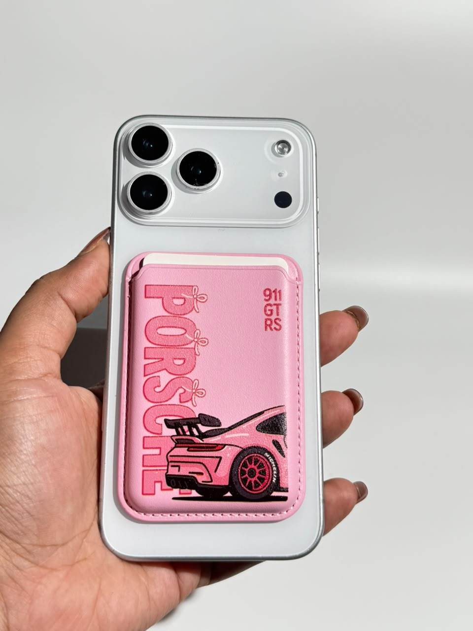 Pink sports car MagSafe wallet on iPhone