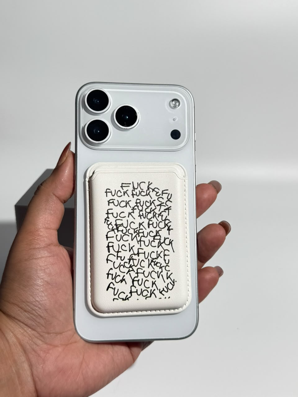Unfiltered Ink white MagSafe wallet on iPhone